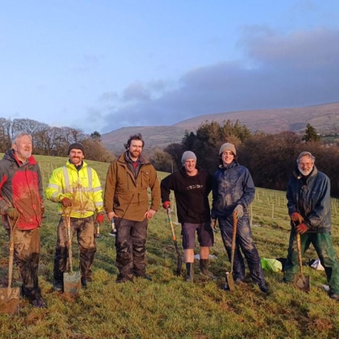 a group of volunteers participating in a tree planting project