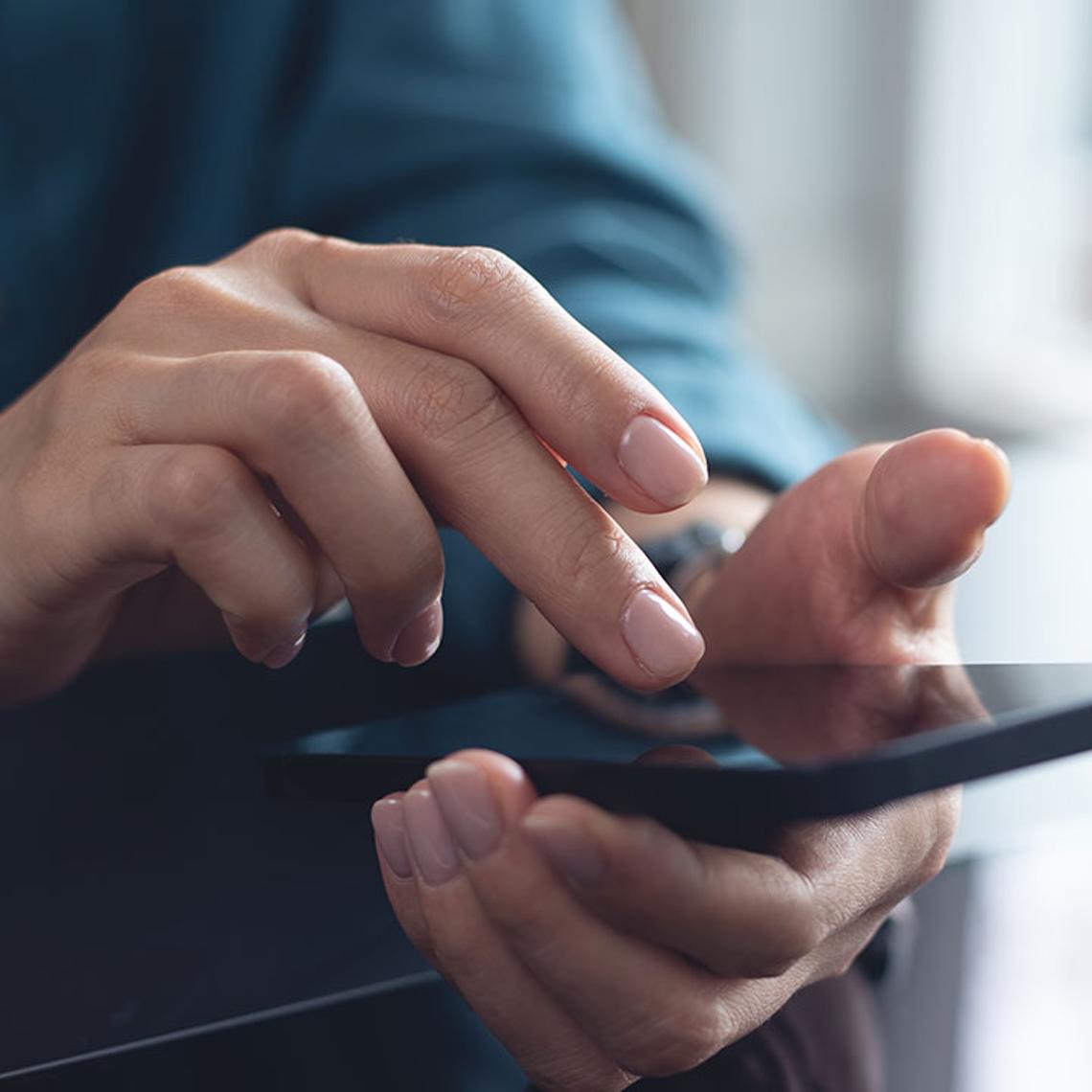 Hands using a mobile phone