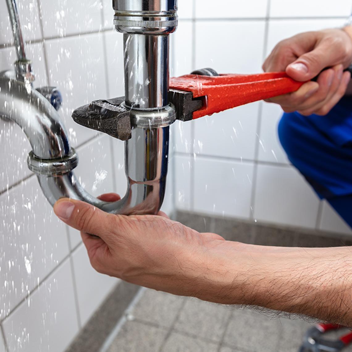 Picture of a plumber doing a repair 