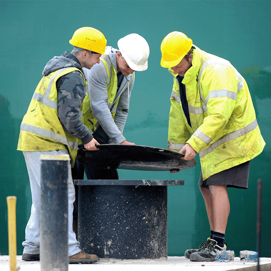 3 workers surrounding a borehole