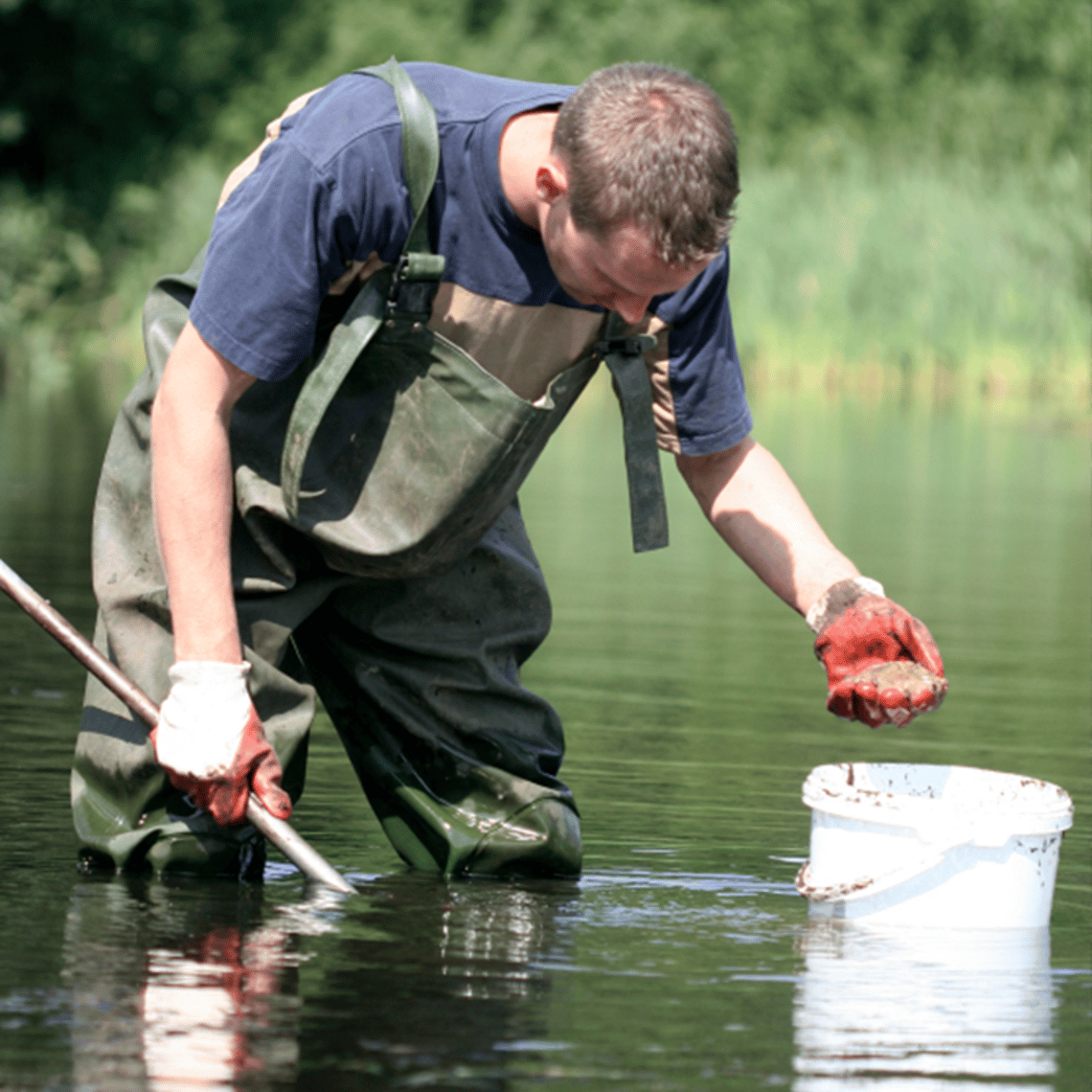 Man cleaning river
