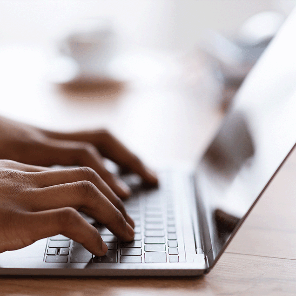 Close up image of a hand using a laptop