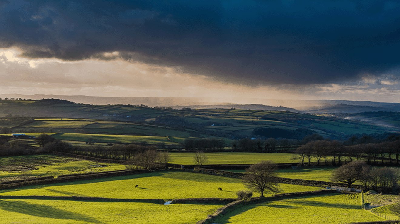 Picture of a dark storm over some hills 
