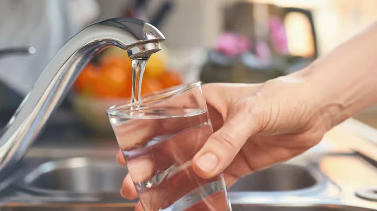 Filling a glass with tap water