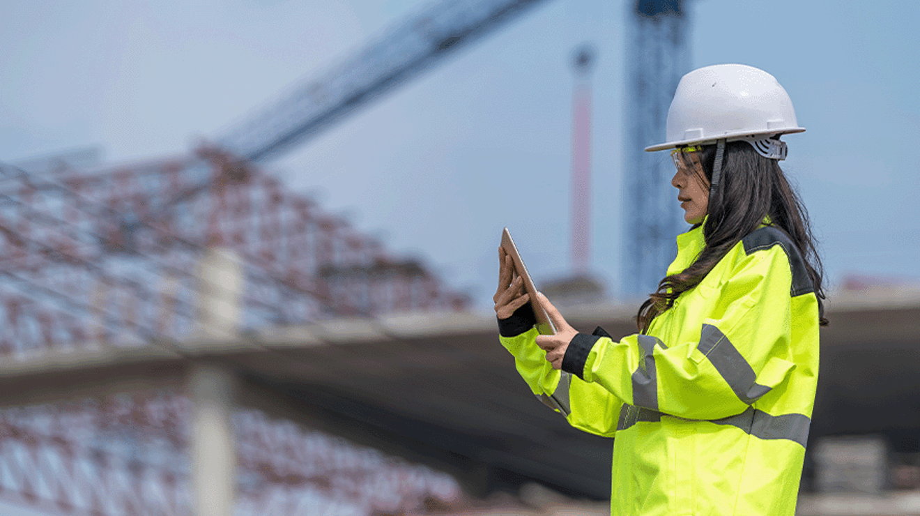 Female builder wearing a hard hat and a hi vis jacket