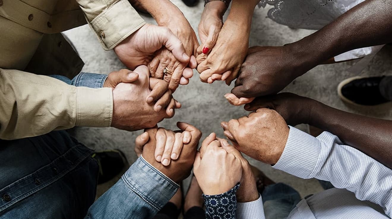 Diverse circle of hands linked