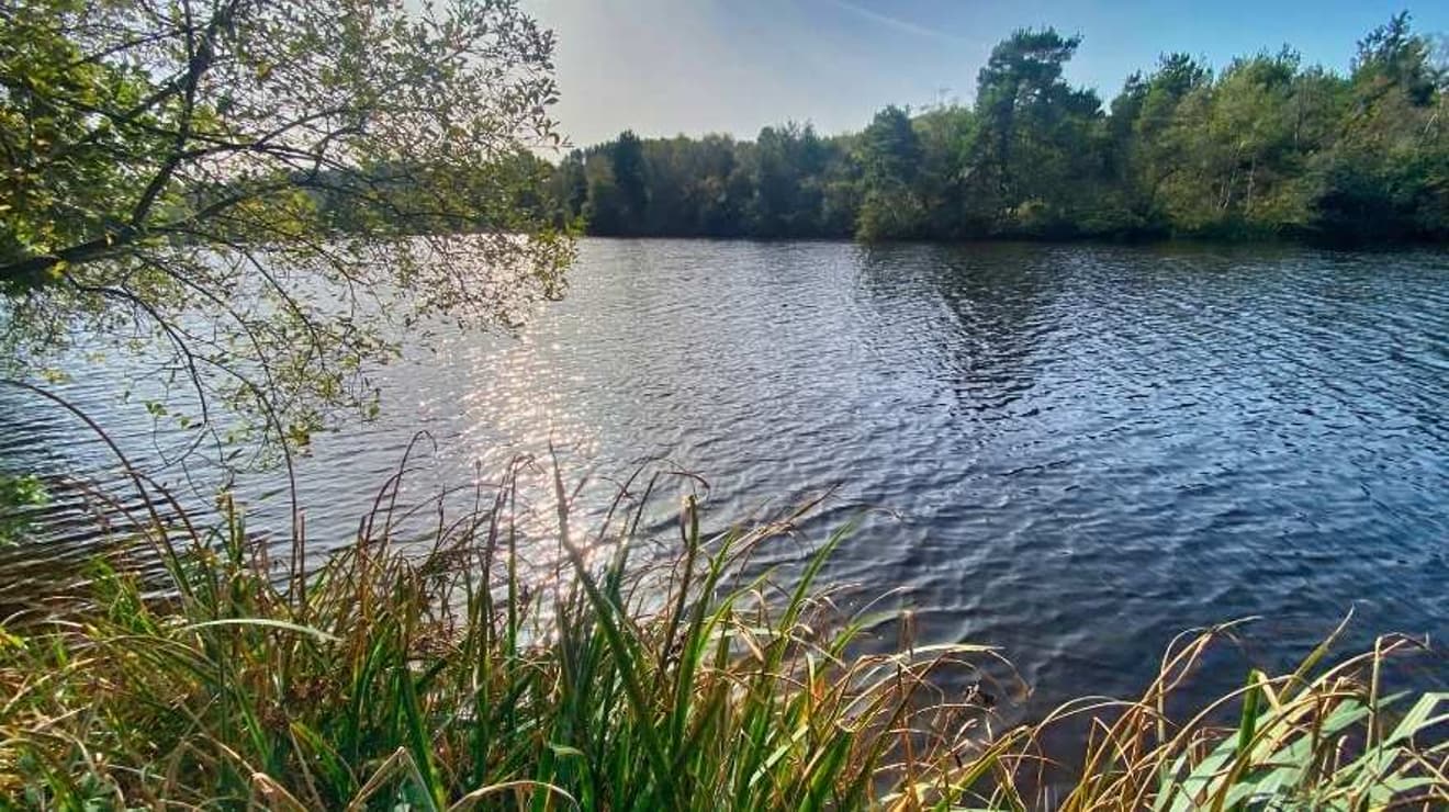 Squabmoor reservoir with blue skies overhead