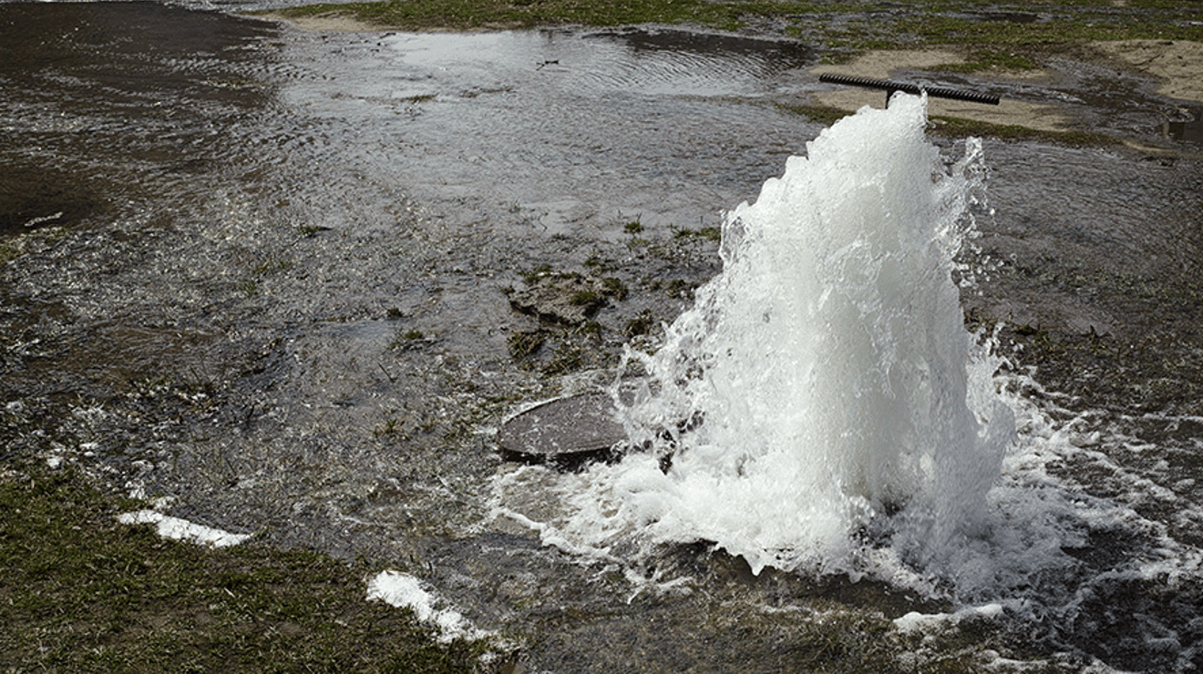 Burst water main in road