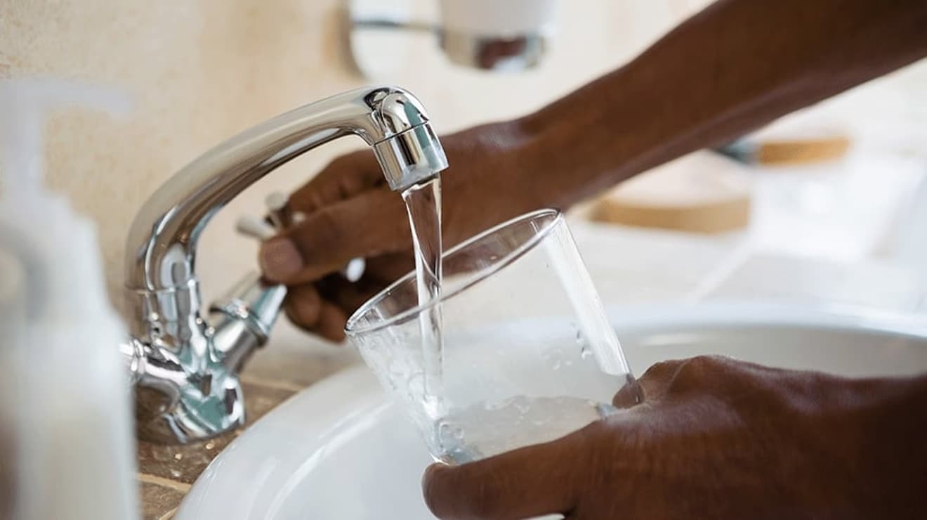 Close up of hand turning tap on