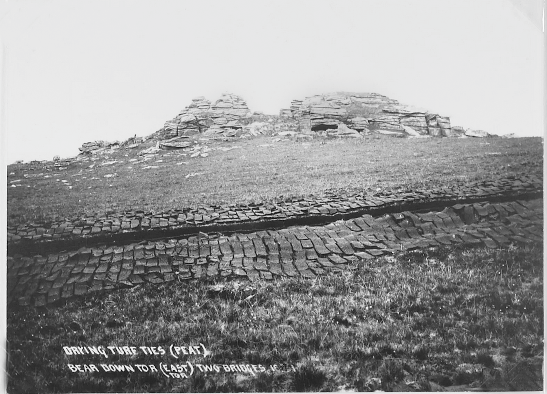 Black and white photograph of drying turf tiles on the moor