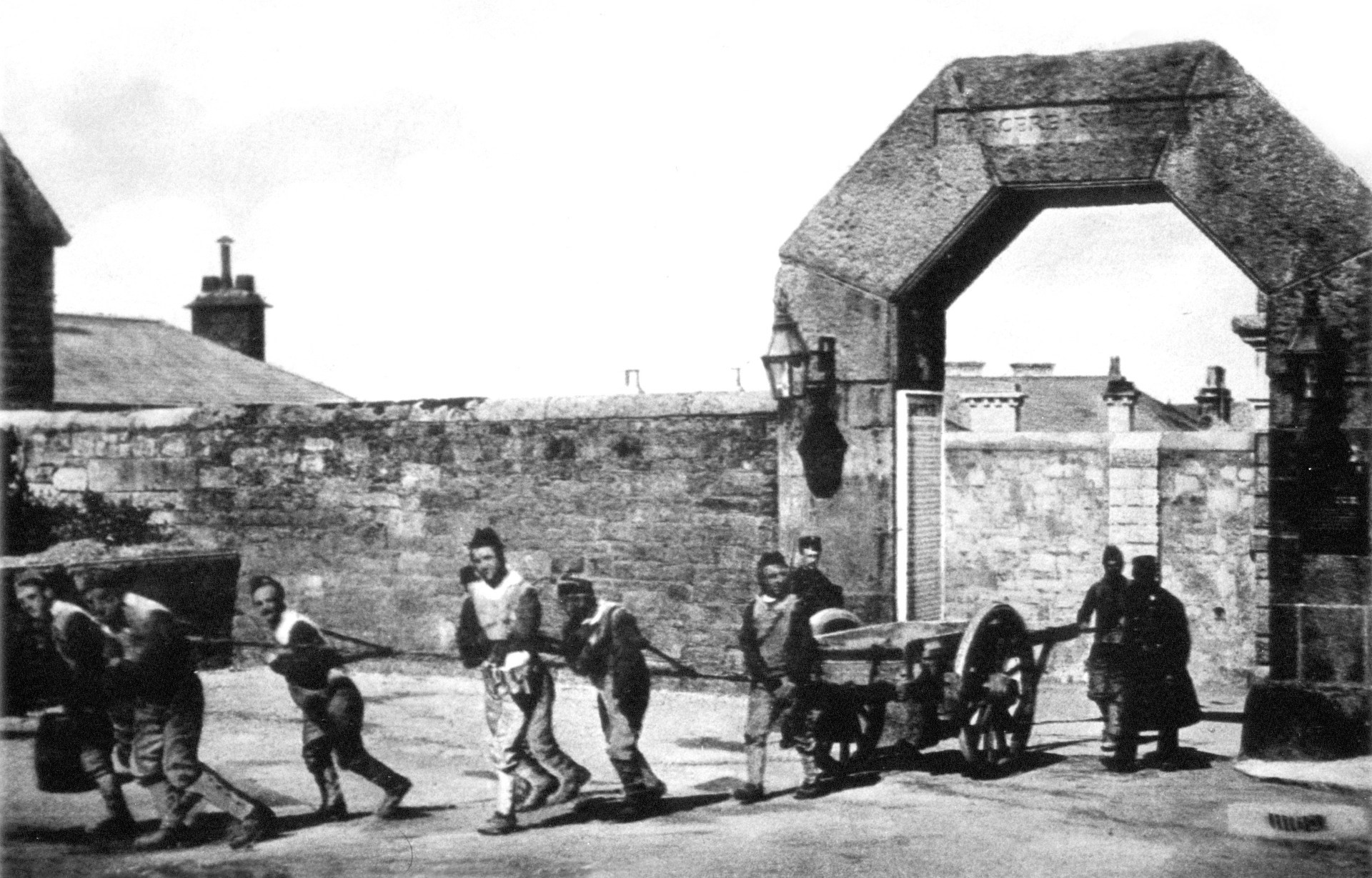 Black and white photograph of prisoners being escorted to the moor