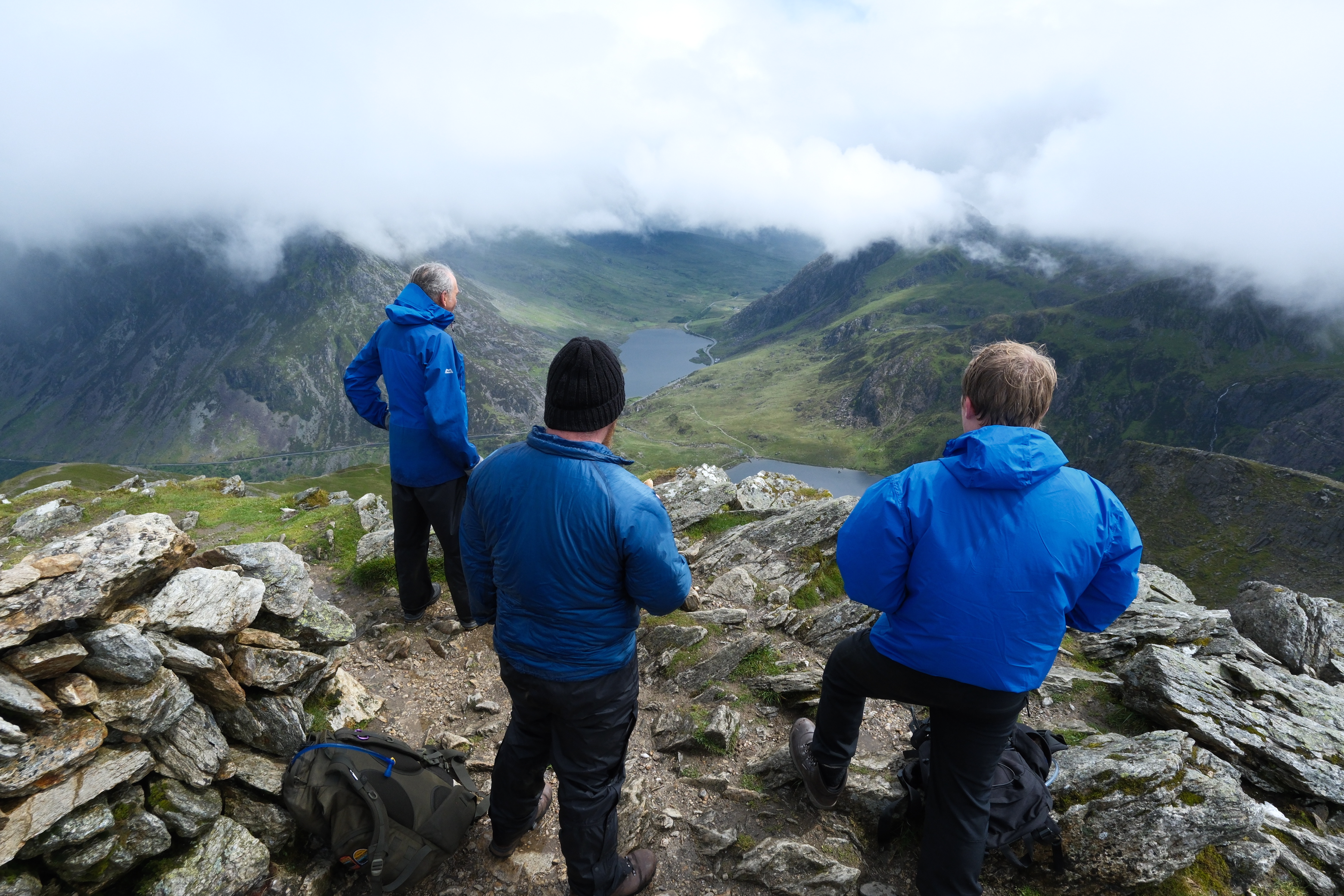 Three South West Water employees stood on Mt Snowdon