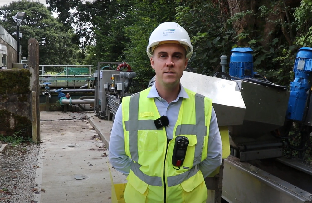 South West Water employee standing at a storm overflow site