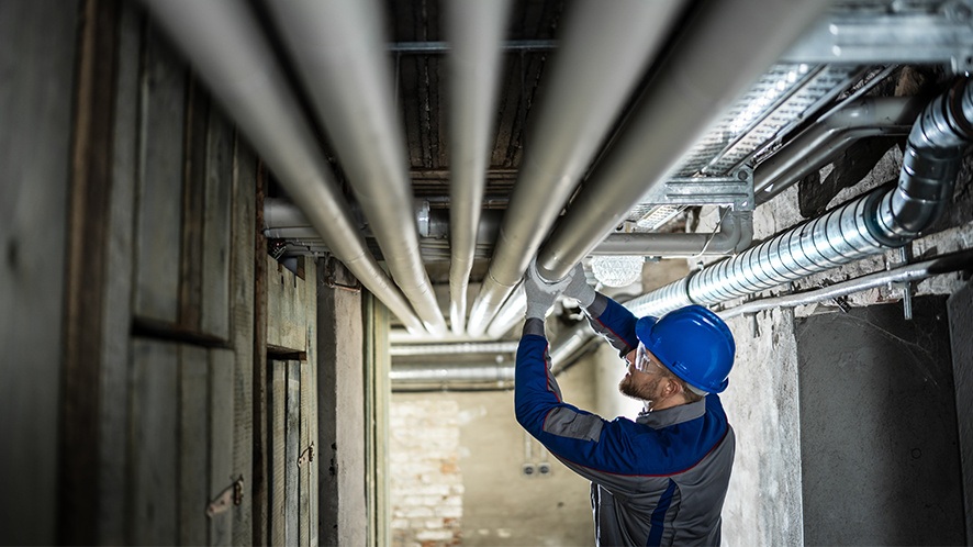 man fitting pipes