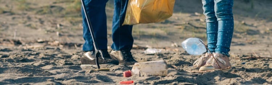 An image of two people picking litter