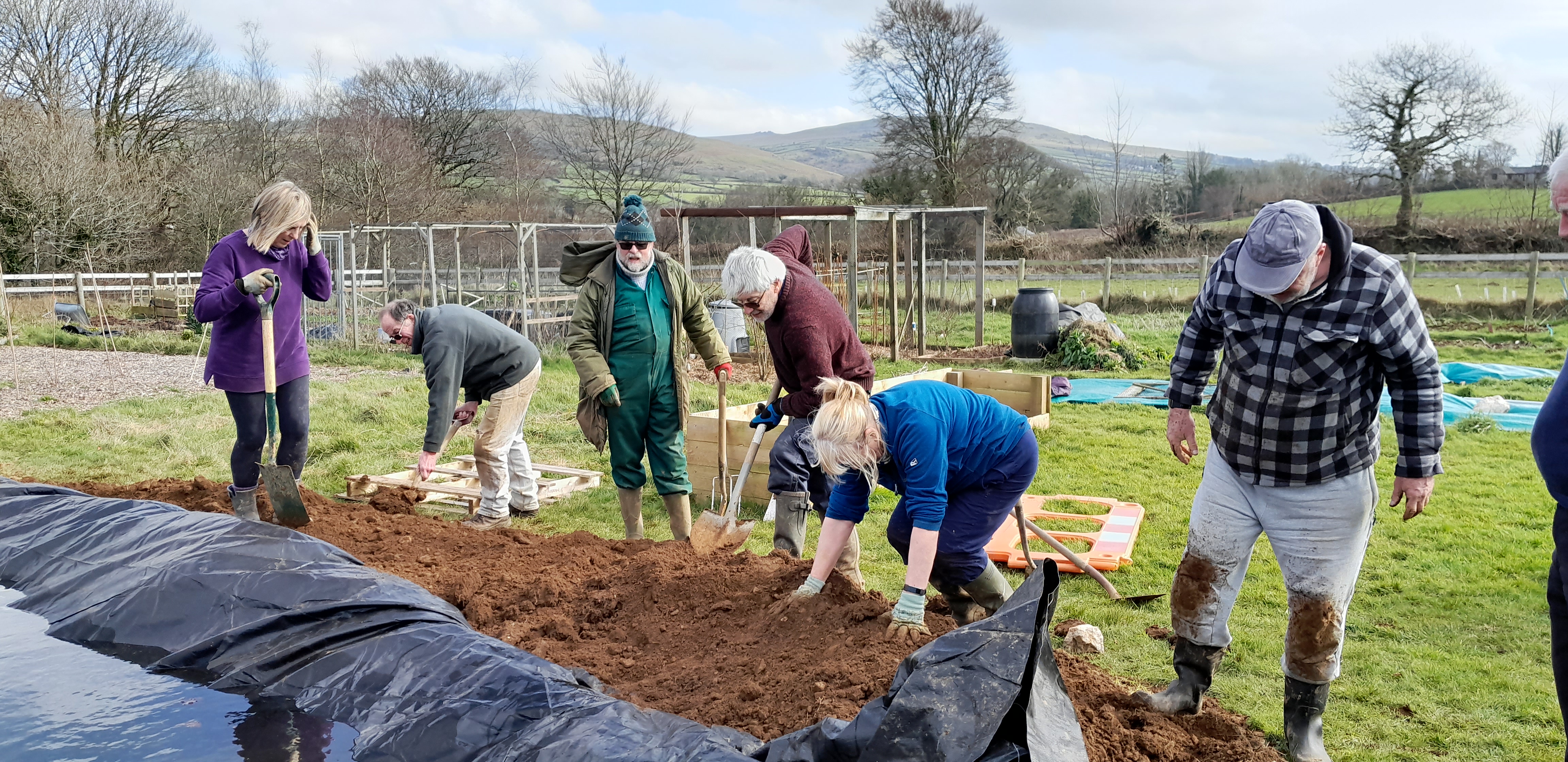 a photo showing people digging the pond