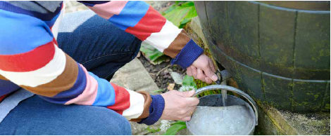 person using a water butt 