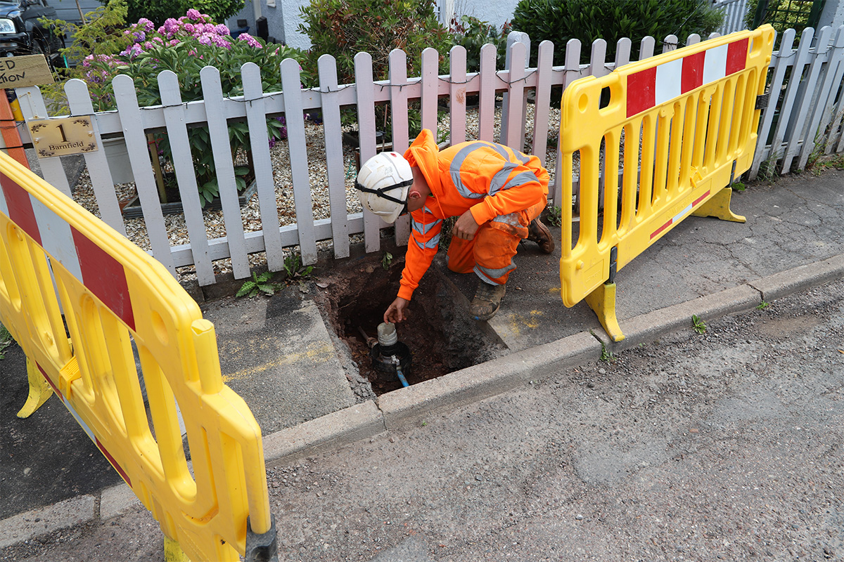 Staff looking at lead pipe